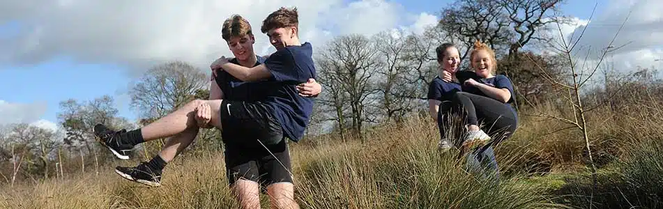 Students carrying each other